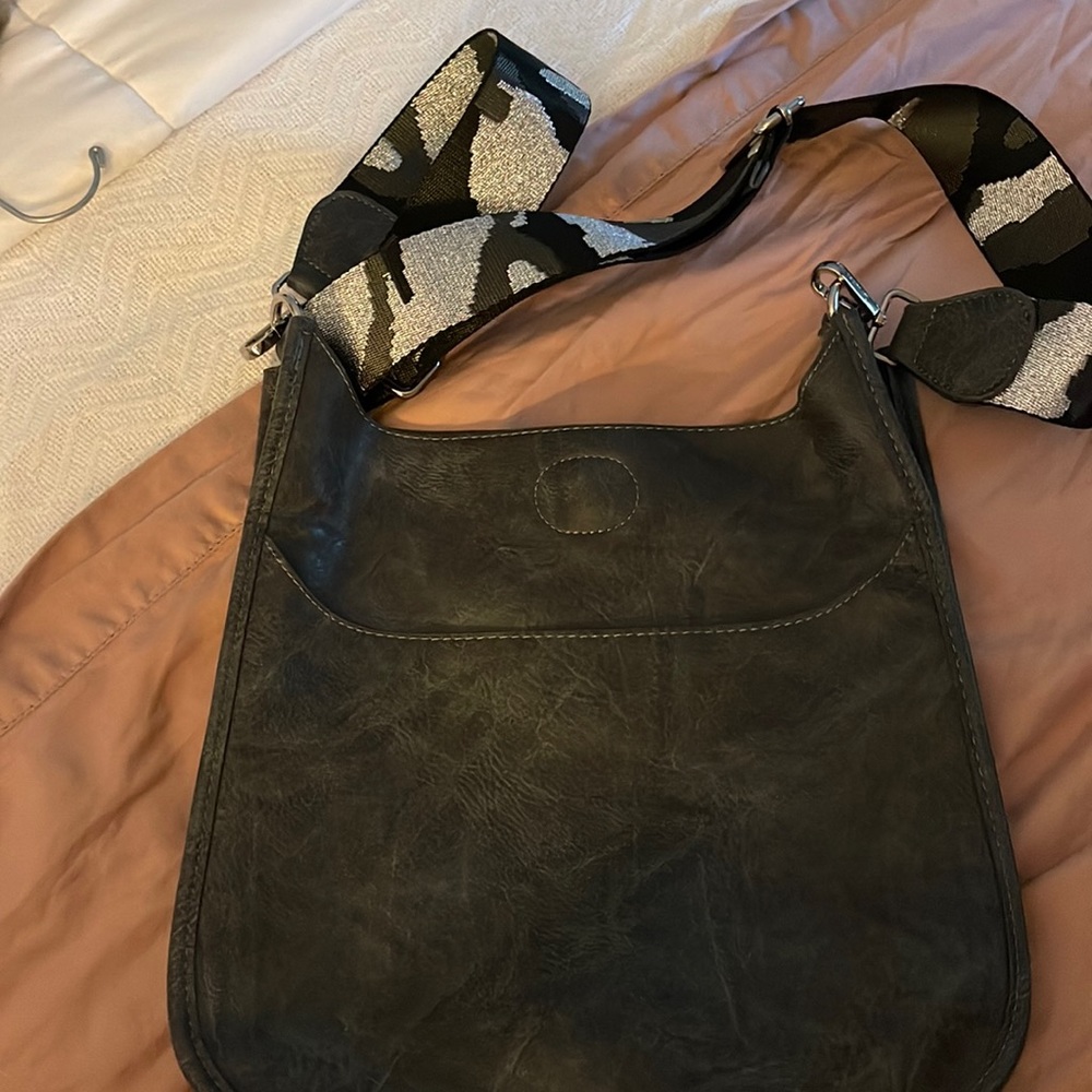 Grey vegan leather crossbody with grey and black animal print guitar strap